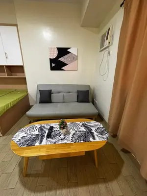 a small room with a bed and a couch at DH Suites in Manila