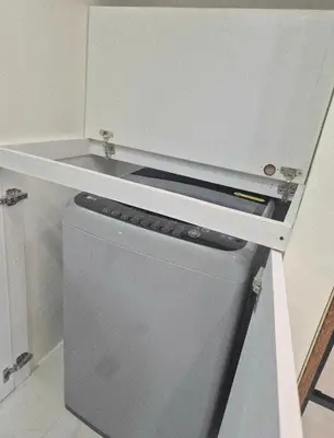 a small refrigerator with a shelf on top of it at Modern Minimalist 1BR Condotel at BGC Taguig in Taguig