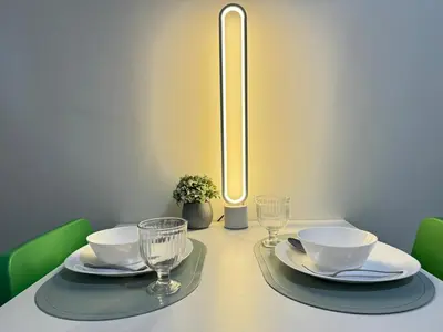 a dining table with two plates and glasses on it at Comfy Spot Staycation Studio at Kasara Urban Pasig in Manila
