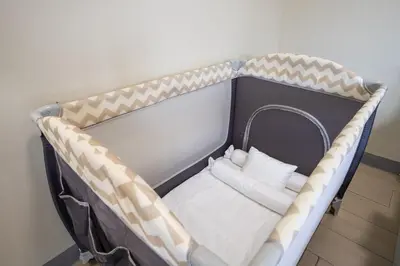a bench with two white pillows in a room at Uptown Parksuites BGC Stylish 2BR Fast WiFi Washer Balcony in Manila
