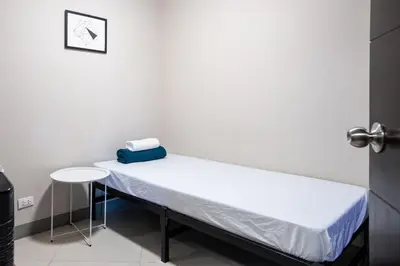 a hospital room with a bed and a table at Uptown Parksuites BGC Stylish 2BR Fast WiFi Washer Balcony in Manila