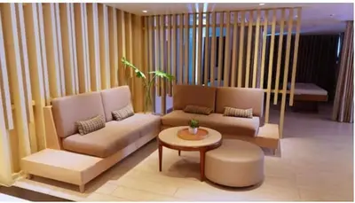 a living room with a couch and a coffee table at Uptown Parksuites BGC Stylish 2BR Fast WiFi Washer Balcony in Manila