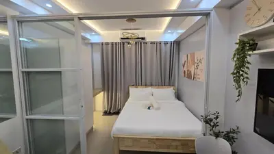 a bedroom with a bed and a clock on the ceiling at Sheena's Suite by Staycation in Manila