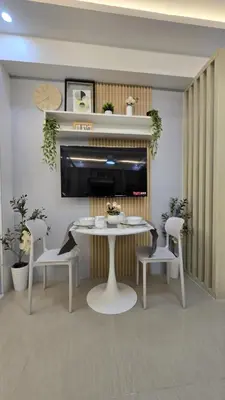 a dining room with a white table and chairs at Sheena's Suite by Staycation in Manila