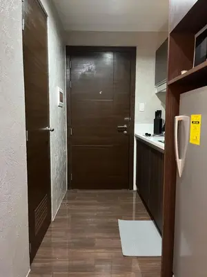 a hallway with a wooden door in a kitchen at Escape Haven in Manila