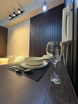 a table with a plate and a wine glass on it at Escape Haven in Manila