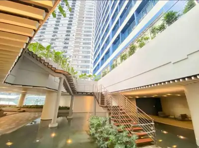 a spiral staircase in a building with a tall building at Escape Haven in Manila