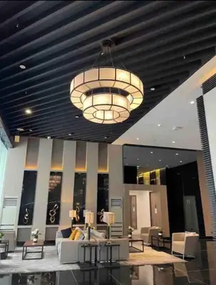 a large lobby with a large chandelier in a building at Escape Haven in Manila