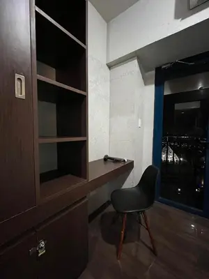 a room with a desk and a chair and a window at Escape Haven in Manila