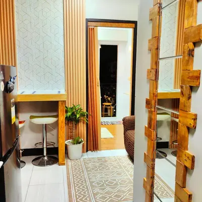 a hallway with a door leading into a room at 1BR Cozy Home with Balcony Near NAIA Terminals in Manila