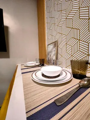 a table with plates and utensils on a table at 1BR Cozy Home with Balcony Near NAIA Terminals in Manila