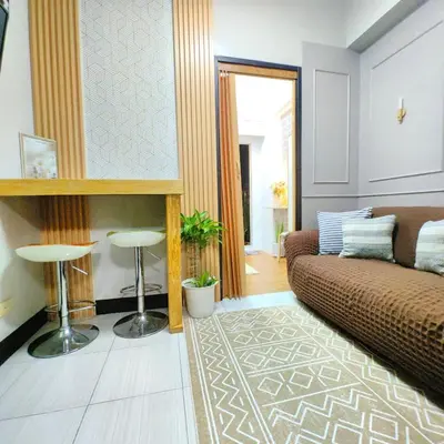 a living room with a couch and a table at 1BR Cozy Home with Balcony Near NAIA Terminals in Manila