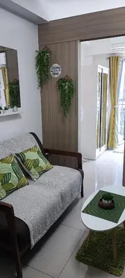 a bedroom with a bed and a table in it at All I Want Relax at Shore Residences in MOA Complex in Manila