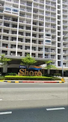 a large building with a sign in front of it at All I Want Relax at Shore Residences in MOA Complex in Manila