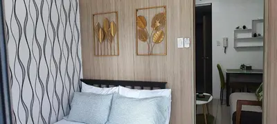 a bedroom with a bed and some pictures on the wall at All I Want Relax at Shore Residences in MOA Complex in Manila