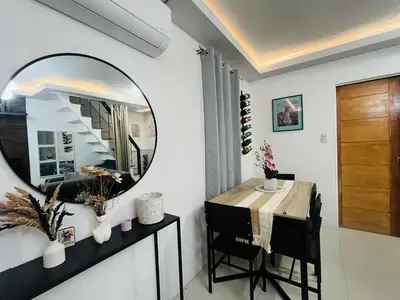 a dining room with a mirror and a table at Balai Sais - Your Scenic Home Away from Home! in Binangonan
