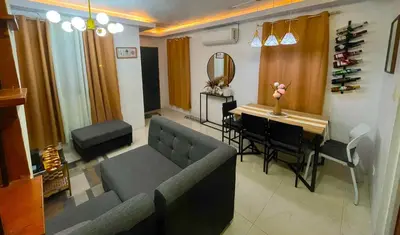 a living room with a couch and a table and a mirror at Balai Sais - Your Scenic Home Away from Home! in Binangonan