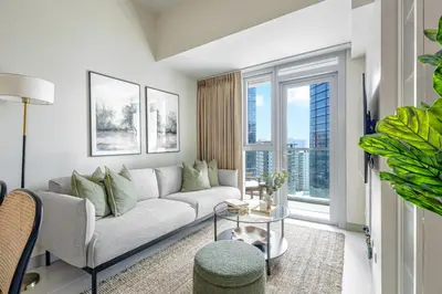 a living room with a couch and a large window at Stylish 2 BR Home with Bathtub and Balcony Uptown BGC in Manila