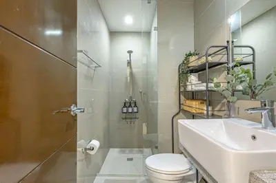 a bathroom with a toilet and a sink at Stylish 2 BR Home with Bathtub and Balcony Uptown BGC in Manila