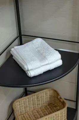 a black table with a white towel on a basket at Stylish 2 BR Home with Bathtub and Balcony Uptown BGC in Manila