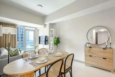 a dining room with a table and a mirror at Stylish 2 BR Home with Bathtub and Balcony Uptown BGC in Manila