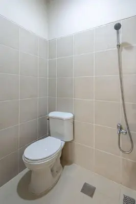 a bathroom with a toilet and a shower at Stylish 2 BR Home with Bathtub and Balcony Uptown BGC in Manila