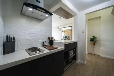 a kitchen with a stove and a counter top at Scandi 1 BR Home Golf View BGC in Manila