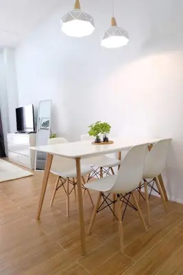 a dining room with a white table and chairs at Golf Penthouse Balcony BGC in Manila