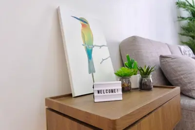 a coffee table with a picture of a bird on it at Golf Penthouse Balcony BGC in Manila