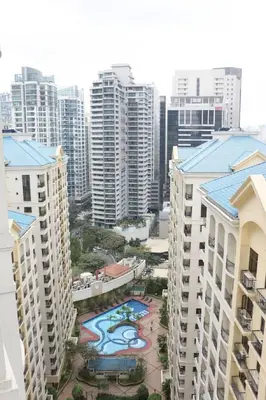an aerial view of a city with tall buildings at Julias Bright Stylish Condo Balcony in Manila