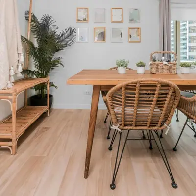 a dining room with a wooden table and chairs at Julias Tropical Oasis Golf Skyline View in Manila