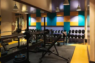 a gym with lots of equipment in a room at Julias Tropical Oasis Golf Skyline View in Manila