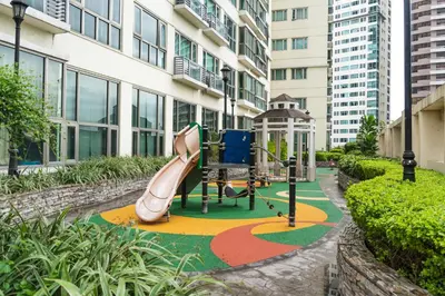 a playground in a building with a slide at Julias Upscale Airy Getaway 1 BR Golf View in Manila