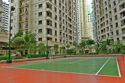 a tennis court in a city with tall buildings at Julias Attractive and Cozy Penthouse Golf View in Manila