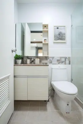 a bathroom with a toilet and a sink at Julias Contemporary Apt Balcony and Golf View in Manila