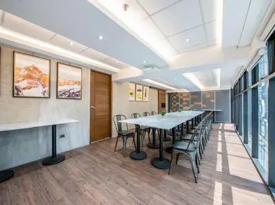 an office meeting room with a long table and chairs at Solace Hotel in Manila