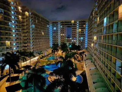 a view of a hotel with a swimming pool at night at RJ Shell Staycation -PD in Manila