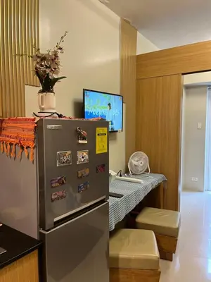 a kitchen with a refrigerator and a desk with a computer at RJ Shell Staycation -PD in Manila