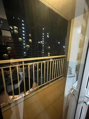a balcony with a view of a city at night at RJ Shell Staycation -PD in Manila