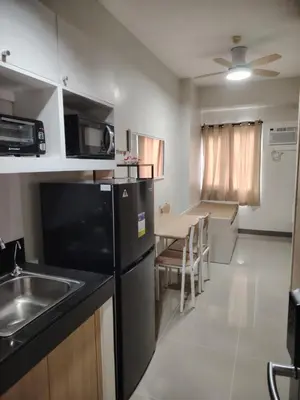 a small kitchen with a sink and a table at 2BR Condo SMDC Charm Metro Manila in Manila