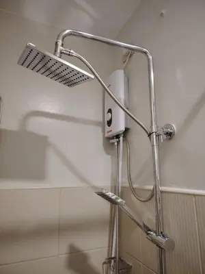 a shower head on a wall in a bathroom at 2BR Condo SMDC Charm Metro Manila in Manila