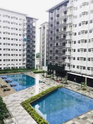 a view of two apartment buildings and a swimming pool at 2BR Condo SMDC Charm Metro Manila in Manila