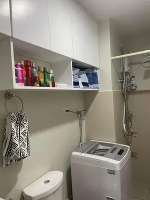 a small bathroom with a toilet and a sink at 2BR Condo SMDC Charm Metro Manila in Manila