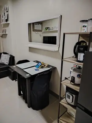 a room with a table with a mirror and a shelf at 2BR Mountain View Condo SMDC Charm Metro Manila in Manila