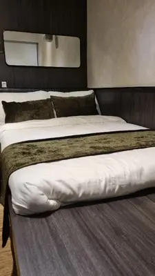 two beds sitting next to each other in a room at Highwind - Projector, Playstation 4, Pool in Silang