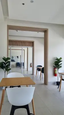 a living room with a table and chairs at Highwind - Projector, Playstation 4, Pool in Silang