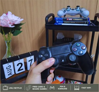 a person holding a nintendo wii game controller at Shore Residences - Near Mall of Asia in Manila