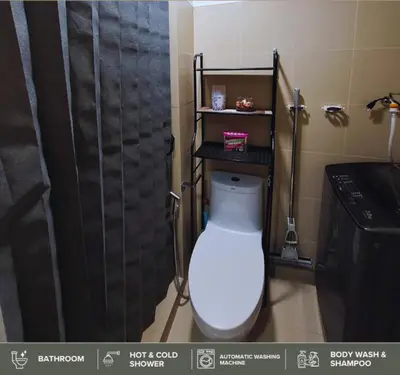 a bathroom with a toilet and a black shower at Shore Residences - Near Mall of Asia in Manila