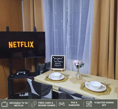 a table with two plates and a sign on it at Shore Residences - Near Mall of Asia in Manila