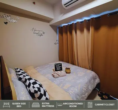 a bedroom with a bed with a sign on it at Shore Residences - Near Mall of Asia in Manila